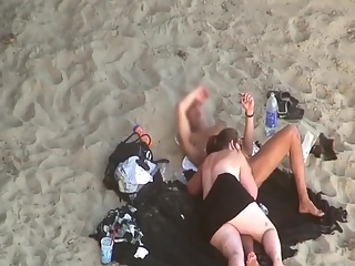 your voyeur videos - Chubby woman blows cock in the beach