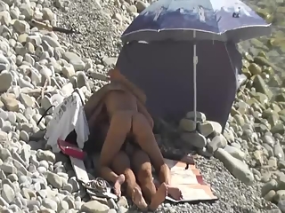 your voyeur videos - Nudist woman lying down in the sun sunbathing