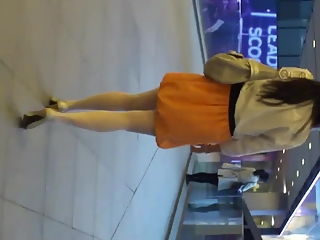 your voyeur videos - Woman in orange skirt upskirted